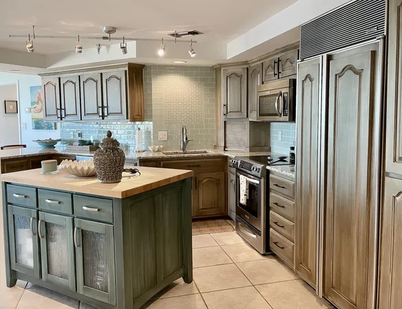 a kitchen with stainless steel appliances a sink stove and refrigerator