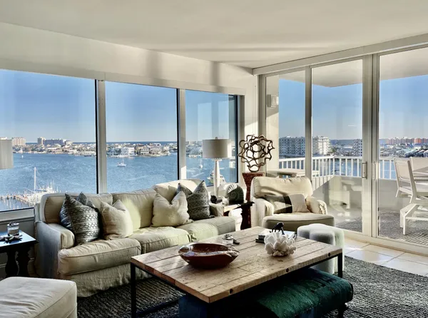 a living room with furniture a large window and a table