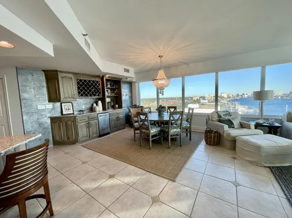 a living room with lots of furniture and kitchen view