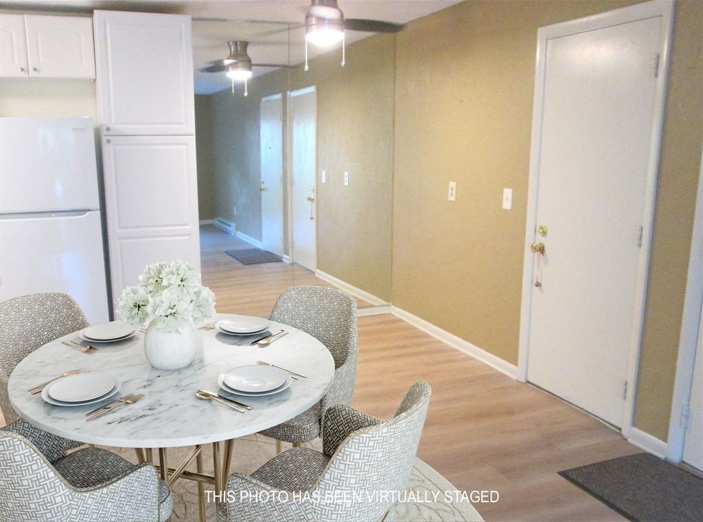 176 Swanson Road, Unit 305 Boxborough, MA 01719 - Photo 4 of 14 a view of a dining room with furniture and wooden floor