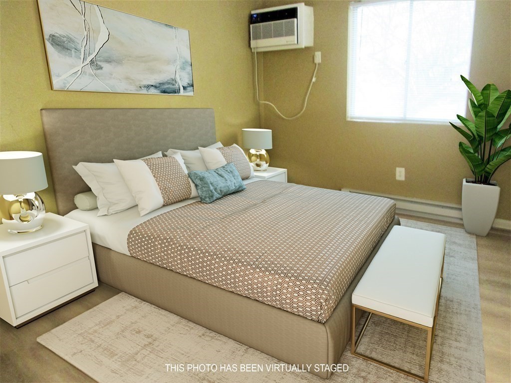 176 Swanson Road, Unit 305 Boxborough, MA 01719 - Photo 5 of 14 a bed room with a bed and a painting on the wall