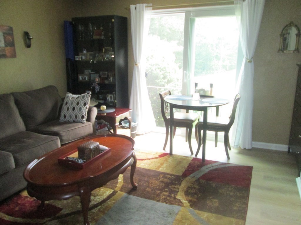 176 Swanson Road, Unit 305 Boxborough, MA 01719 - Photo 8 of 14 a living room with furniture and a large window
