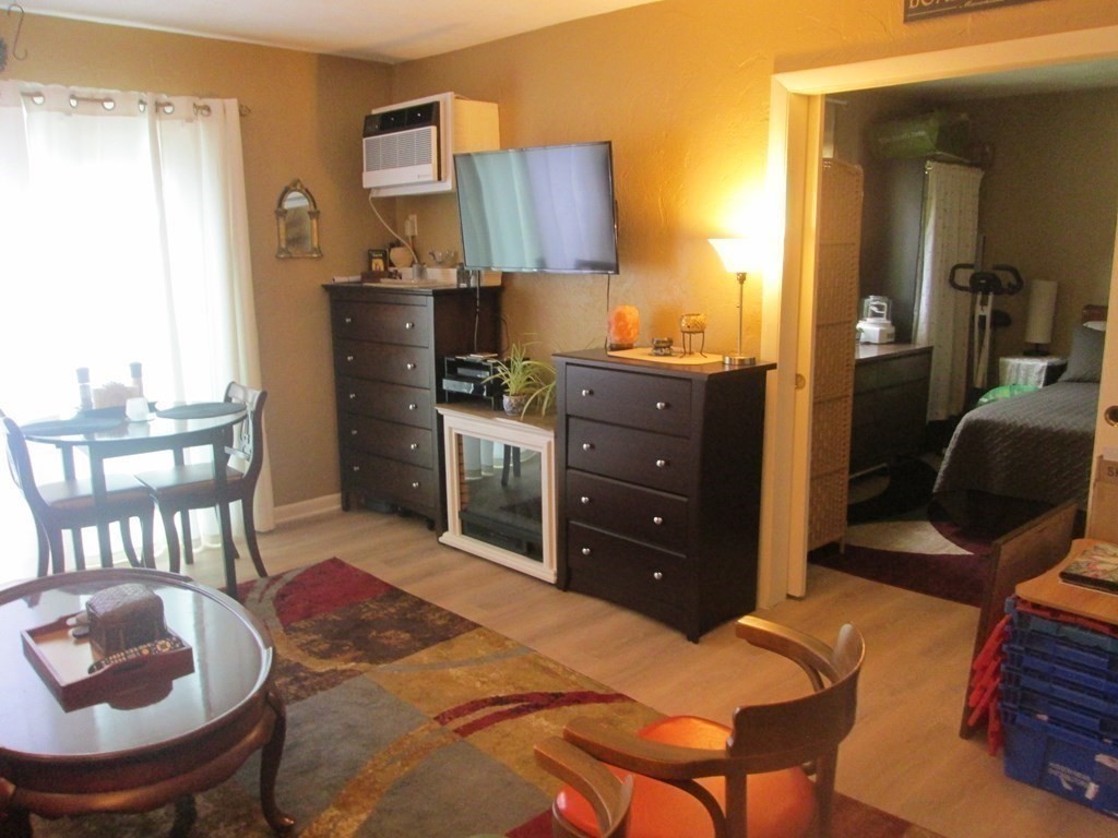176 Swanson Road, Unit 305 Boxborough, MA 01719 - Photo 9 of 14 a bed room with a bed and a chair