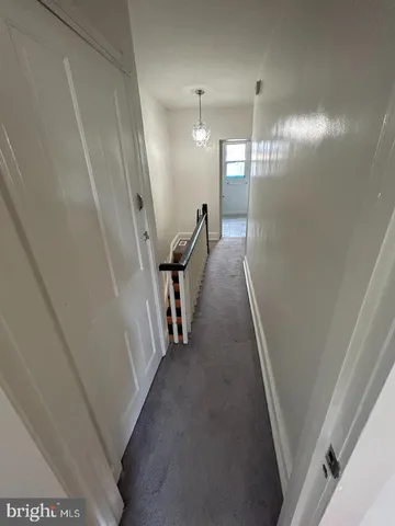 a view of a hallway with a staircase