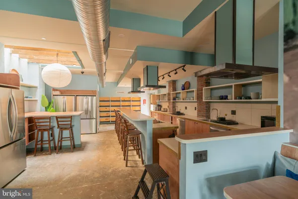 a kitchen with stainless steel appliances a sink a stove and a refrigerator