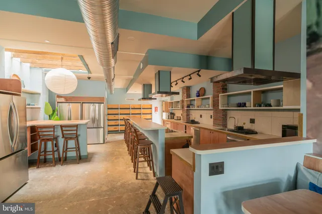 a kitchen with stainless steel appliances a sink a stove and a refrigerator