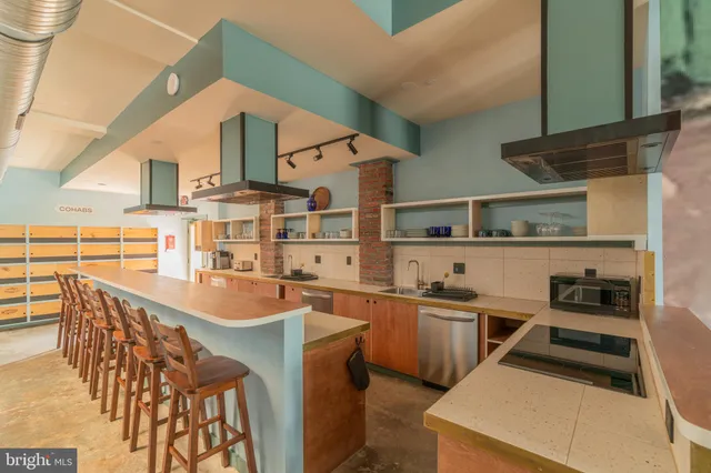 a kitchen with refrigerator a table and chairs