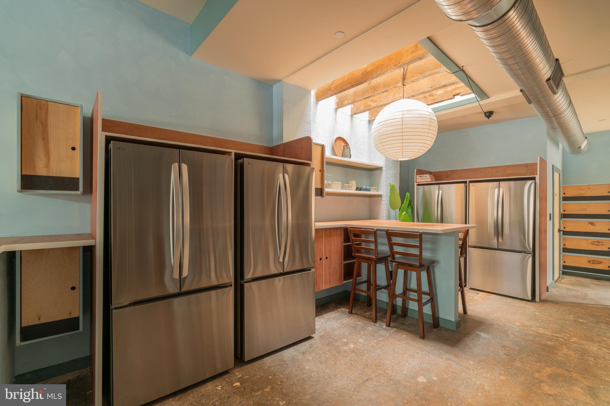 711 G Street Southeast Washington, DC 20003 - Photo 18 of 55 a kitchen with refrigerator a table and chairs