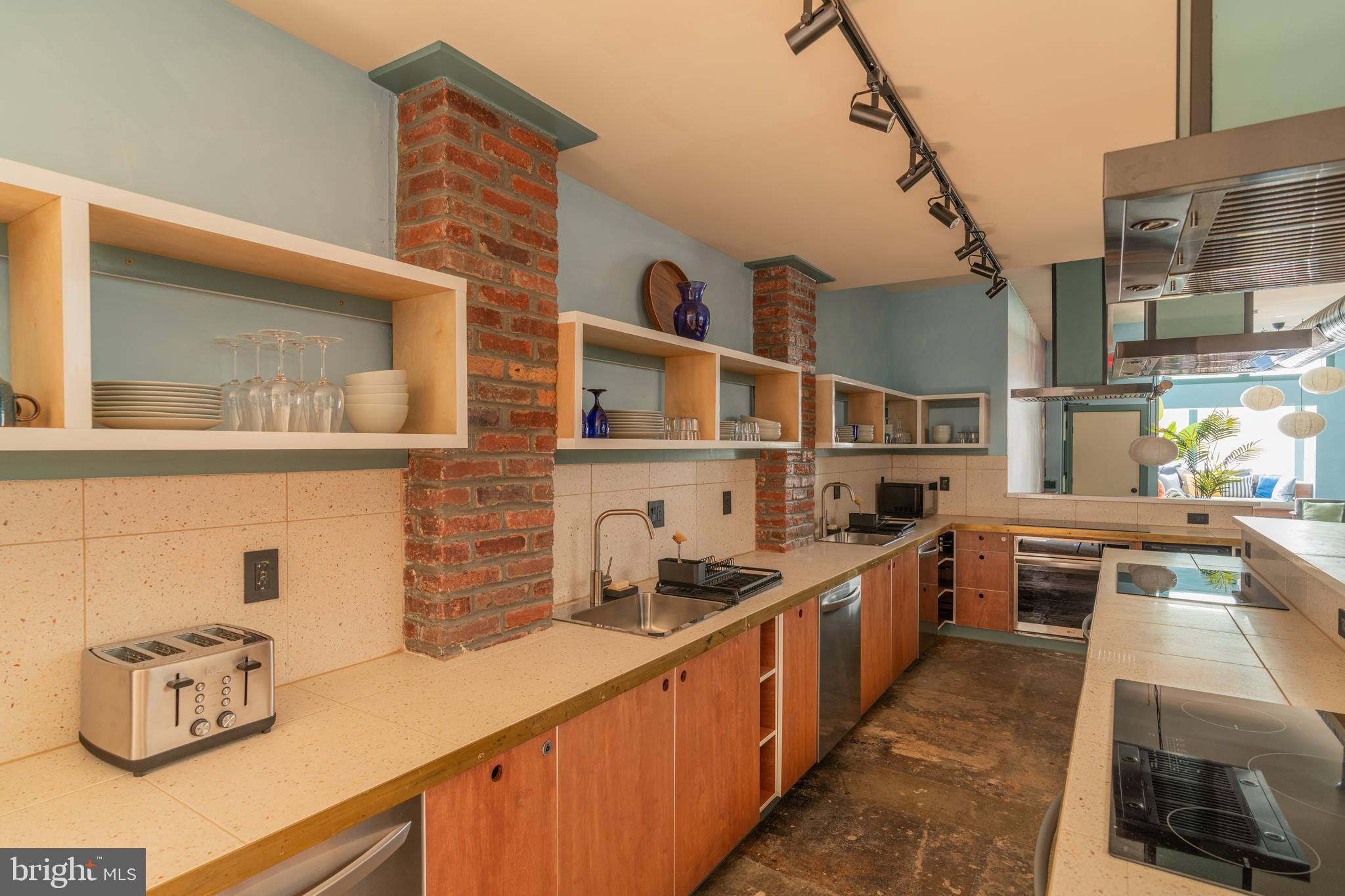 711 G Street Southeast Washington, DC 20003 - Photo 25 of 55 a kitchen with kitchen island granite countertop a sink stove and cabinets