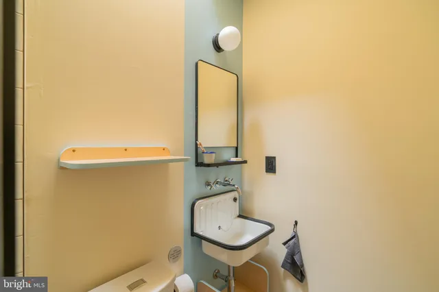 a bathroom with a granite countertop sink a toilet and shower