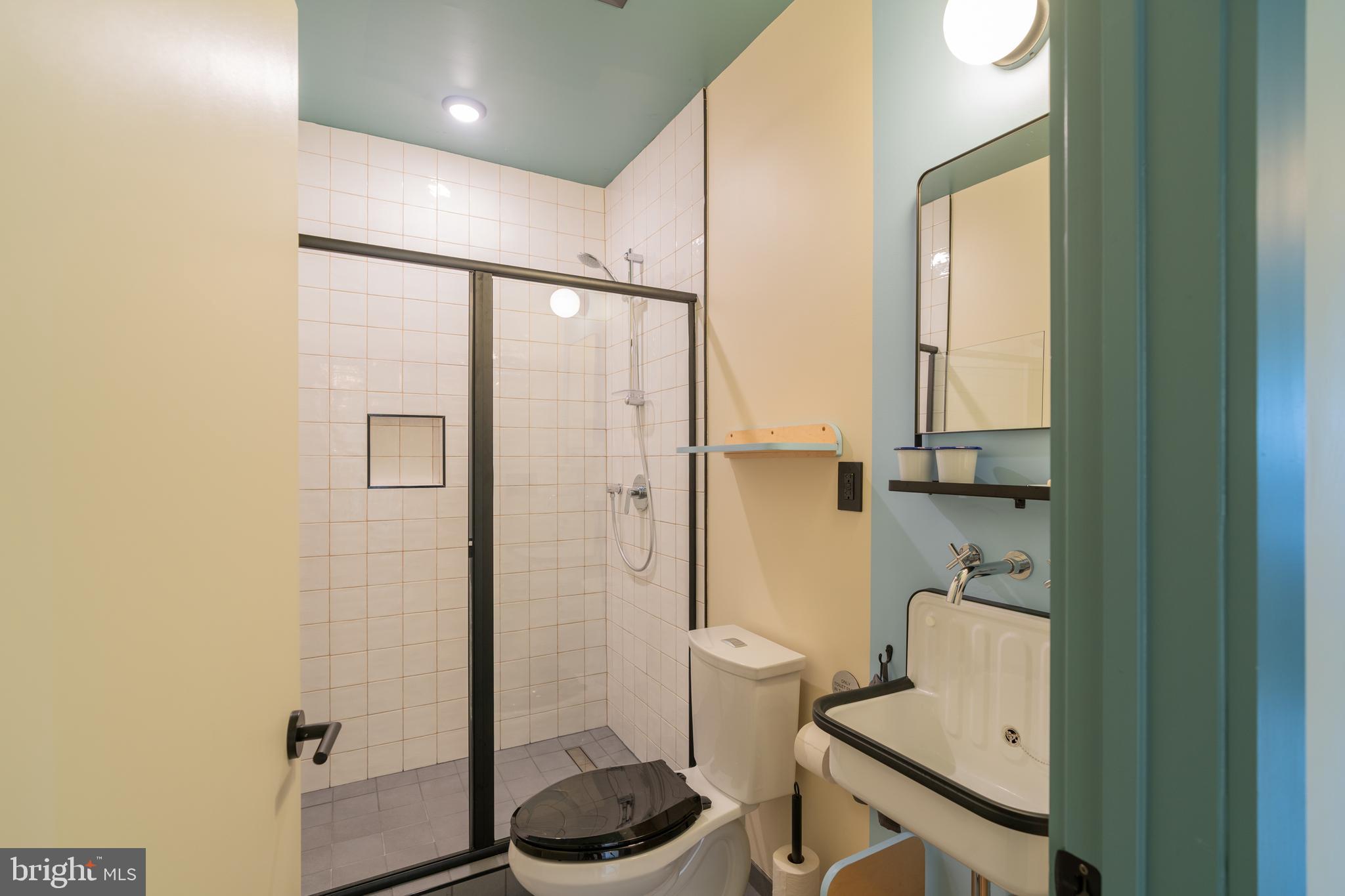 711 G Street Southeast Washington, DC 20003 - Photo 35 of 55 a bathroom with a granite countertop sink a toilet and shower