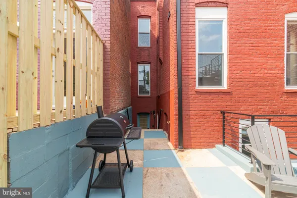 a backyard of a house with outdoor seating