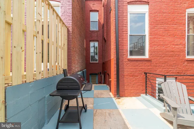 a backyard of a house with outdoor seating
