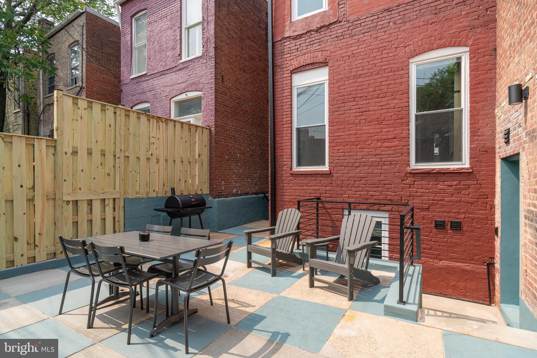 711 G Street Southeast Washington, DC 20003 - Photo 41 of 55 a backyard of a house with a table and chairs