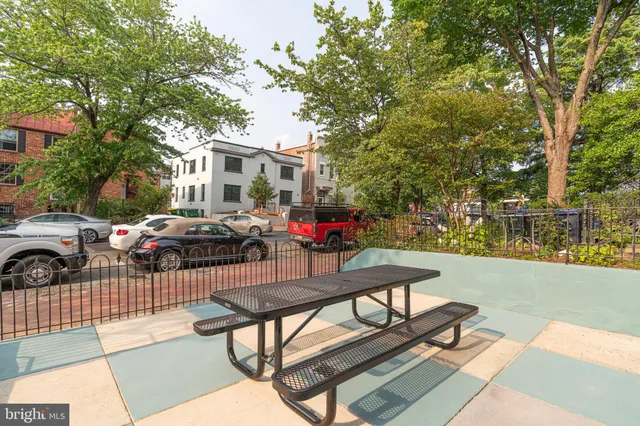 a view of a patio with couches table and chairs and potted plants