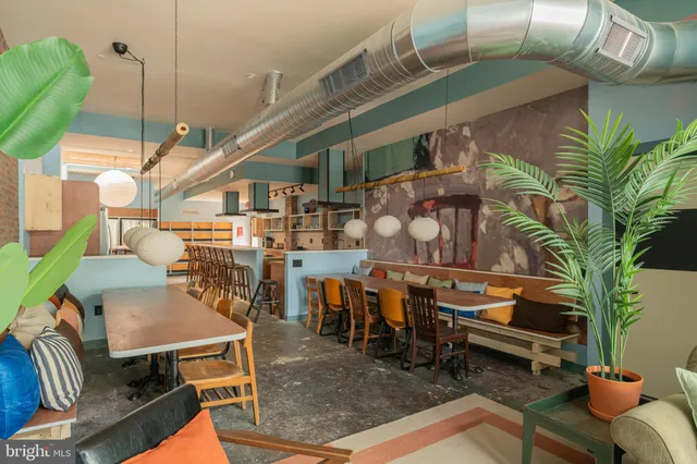 a living room with furniture a large window and a table