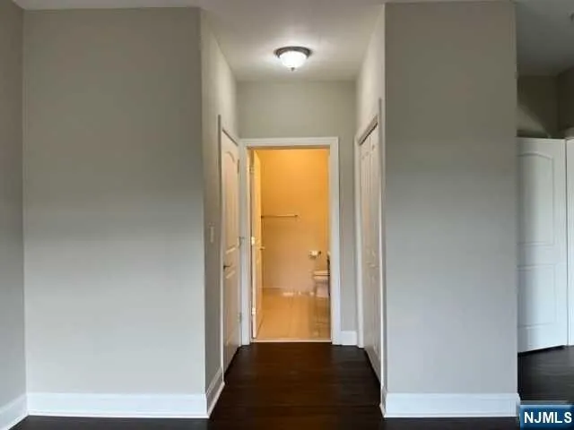 a view of walk in closet with wooden floor