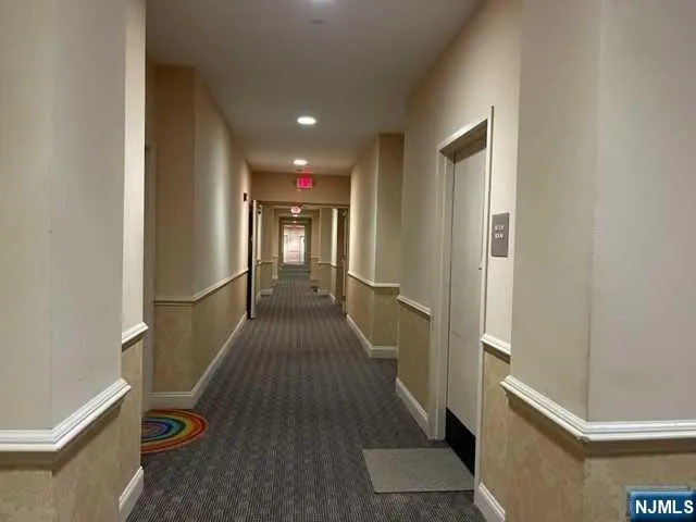 a view of hallway with wooden floor