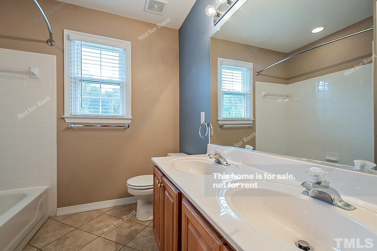 3300 Stone Castle Court Raleigh, NC 27613 - Photo 19 of 24 a bathroom with a granite countertop sink toilet and shower