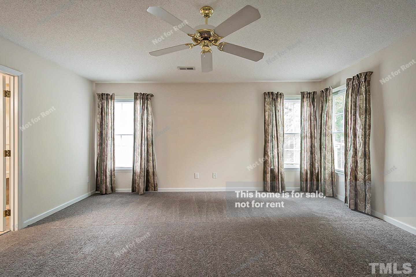 3300 Stone Castle Court Raleigh, NC 27613 - Photo 8 of 24 an empty room with windows and fan