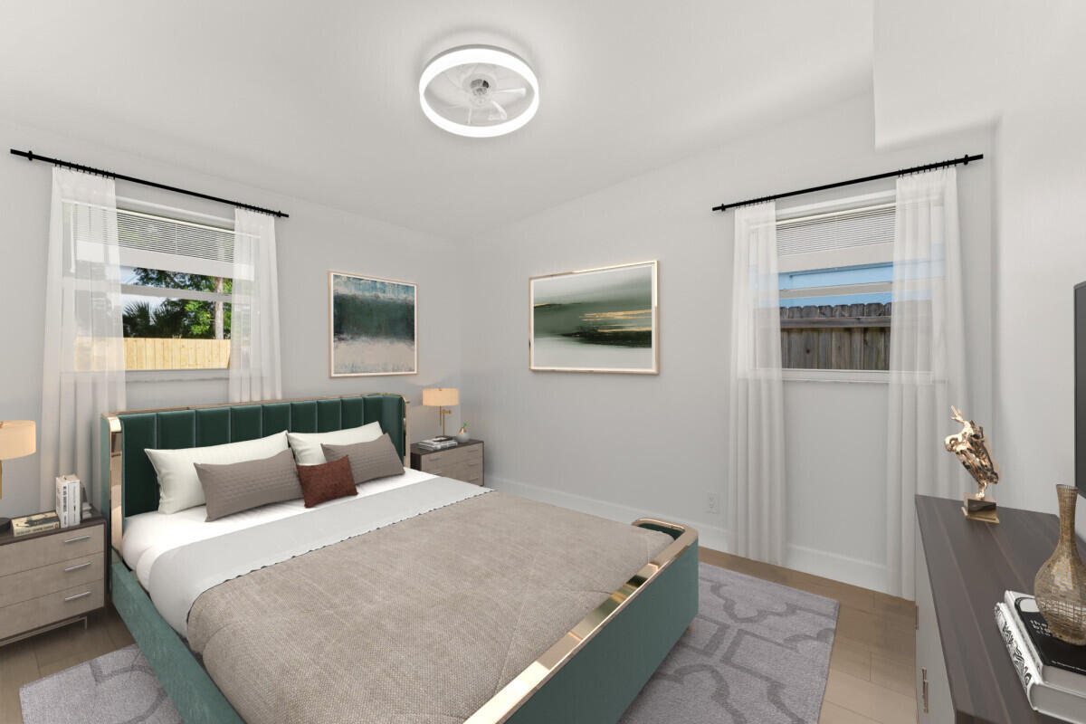 3797 Bahama Road Palm Beach Gardens, FL 33410 - Photo 13 of 27 a bedroom with a bed and a potted plant