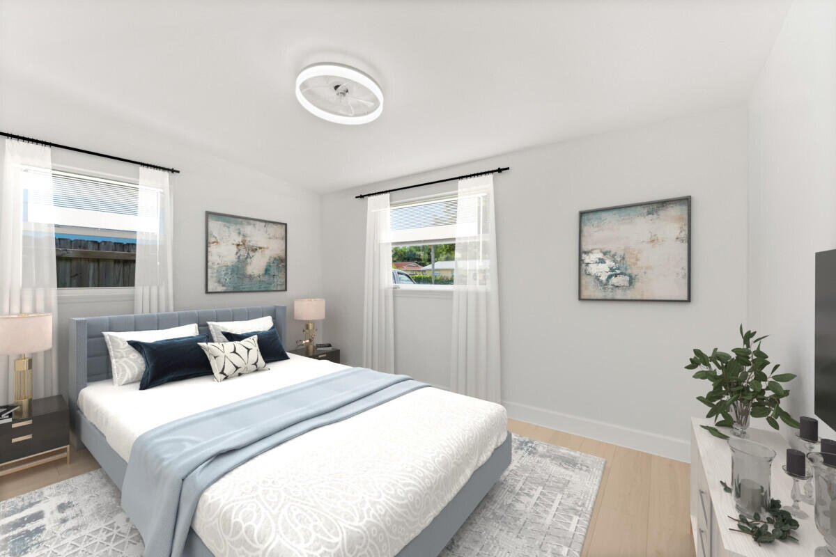 3797 Bahama Road Palm Beach Gardens, FL 33410 - Photo 14 of 27 a bedroom with a large bed and a potted plant