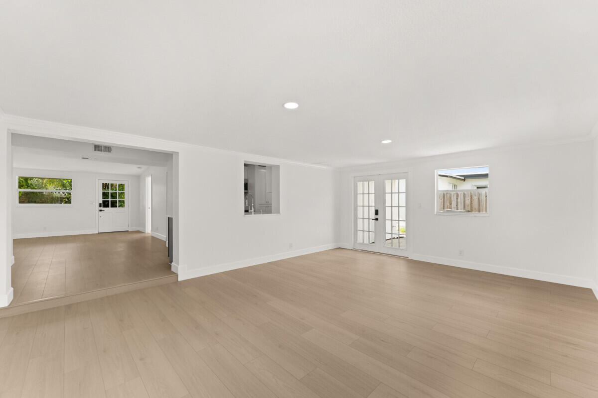 3797 Bahama Road Palm Beach Gardens, FL 33410 - Photo 21 of 27 a view of an empty room with a window and wooden floor