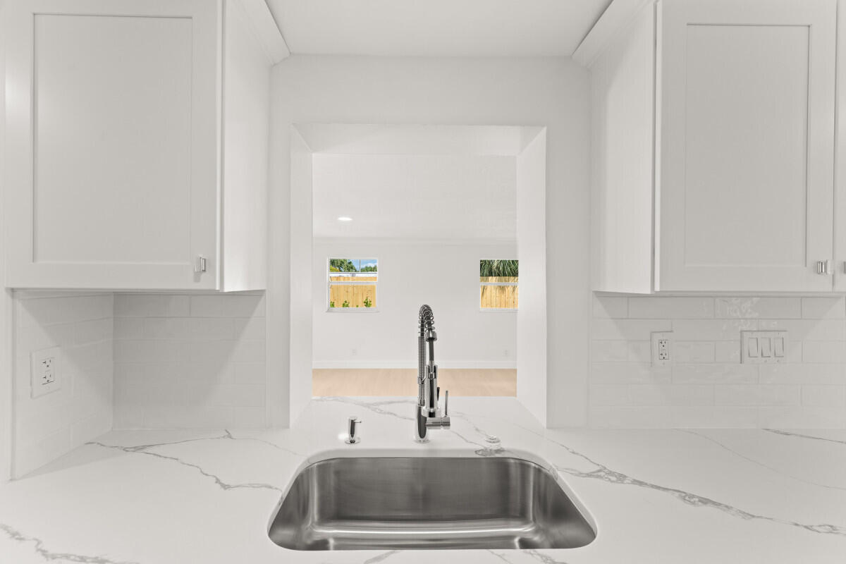 3797 Bahama Road Palm Beach Gardens, FL 33410 - Photo 6 of 27 a kitchen with a sink and cabinets