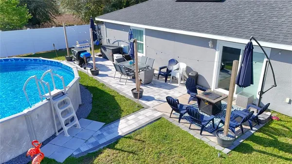 a view of a backyard with table and chairs with wooden fence