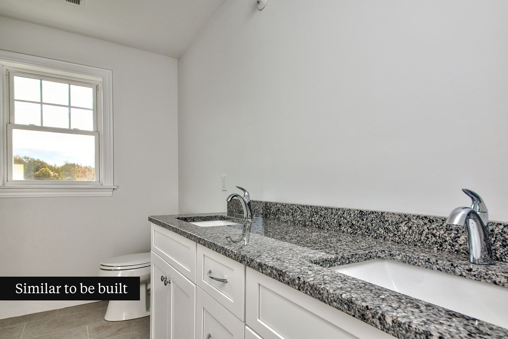 Lot 4 Arrow Path Natick, MA 01760 - Photo 14 of 18 a bathroom with a granite countertop sink and a vanity