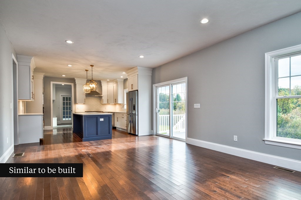 Lot 4 Arrow Path Natick, MA 01760 - Photo 5 of 18 a large kitchen with stainless steel appliances granite countertop a stove a sink a refrigerator and white cabinets with wooden floor