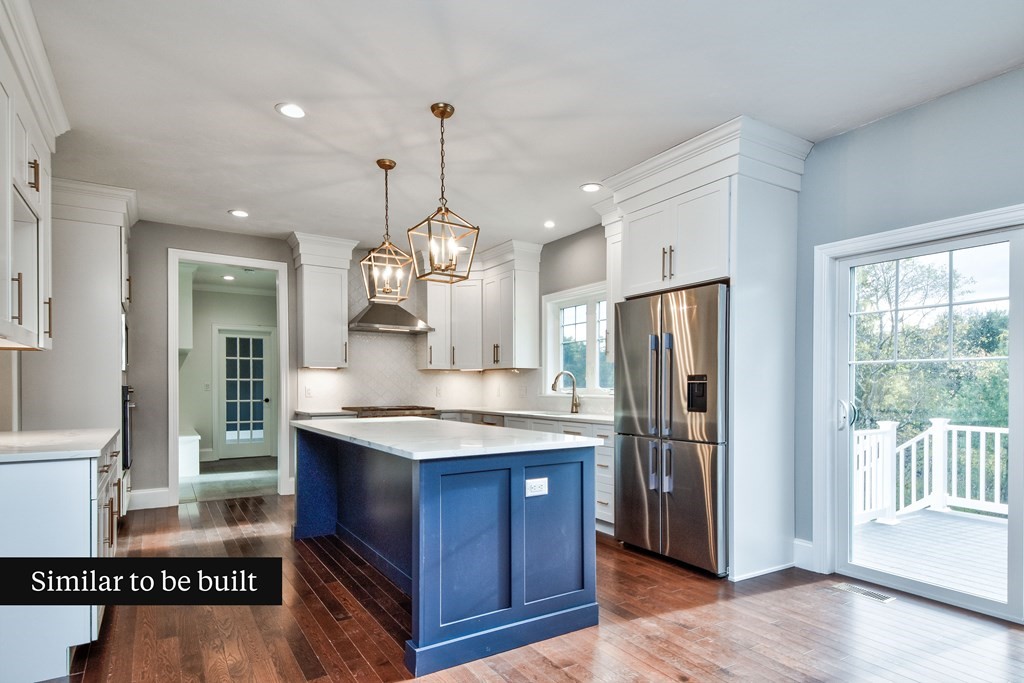 Lot 4 Arrow Path Natick, MA 01760 - Photo 7 of 18 a kitchen with stainless steel appliances granite countertop a refrigerator a sink dishwasher a stove and a dining table with wooden floor