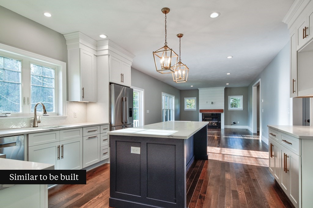 Lot 4 Arrow Path Natick, MA 01760 - Photo 9 of 18 a kitchen with stainless steel appliances granite countertop a sink a stove and a refrigerator