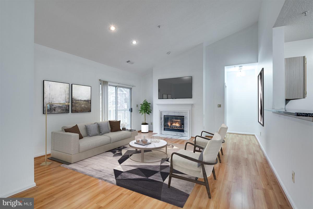 1701 Lake Shore Crest Drive, Unit 34 Reston, VA 20190 - Photo 1 of 28 a living room with furniture a fireplace and a flat screen tv