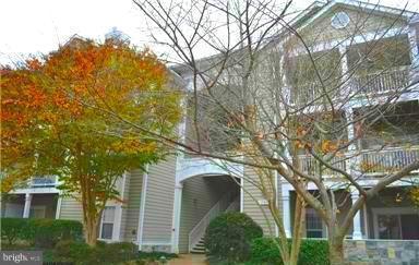 1701 Lake Shore Crest Drive, Unit 34 Reston, VA 20190 - Photo 2 of 28 front view of a house with a tree