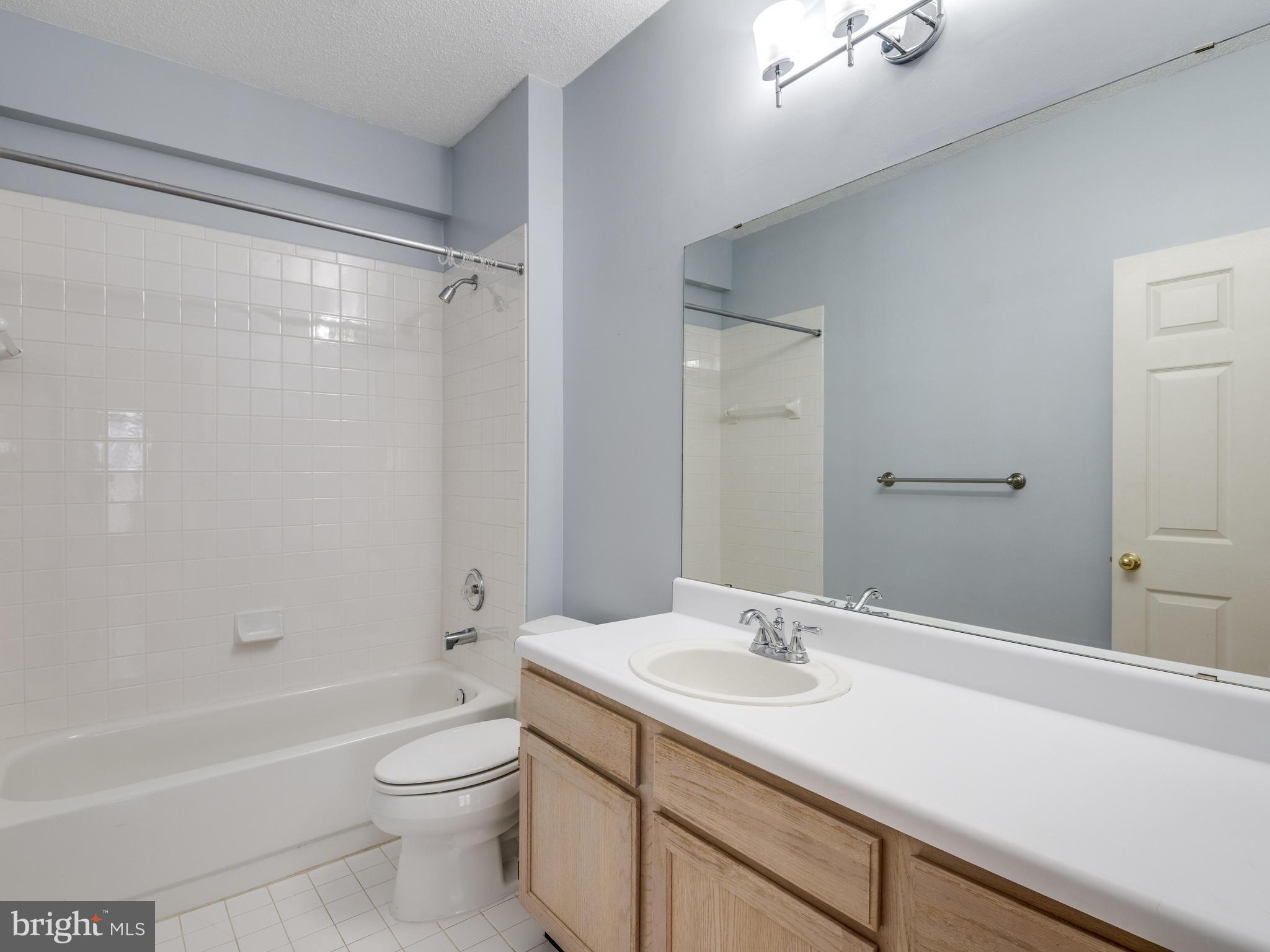1701 Lake Shore Crest Drive, Unit 34 Reston, VA 20190 - Photo 14 of 28 a bathroom with a sink a toilet and shower
