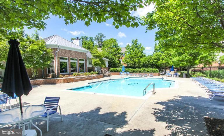 1701 Lake Shore Crest Drive, Unit 34 Reston, VA 20190 - Photo 16 of 28 a view of a swimming pool with a patio