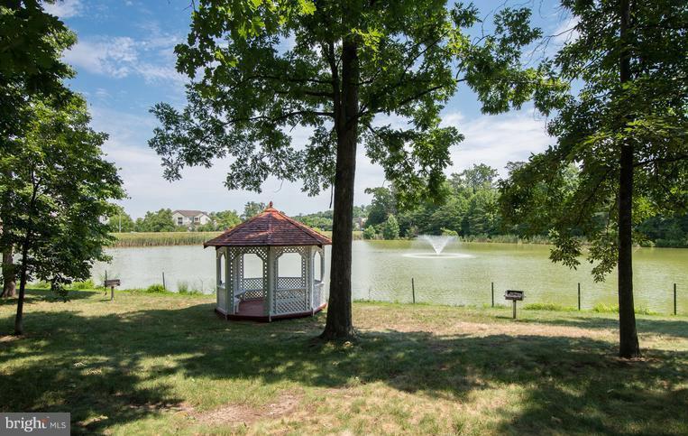 1701 Lake Shore Crest Drive, Unit 34 Reston, VA 20190 - Photo 17 of 28 a backyard of a house with lots of green space and lake view