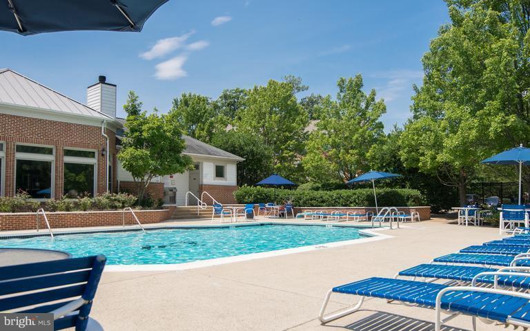 1701 Lake Shore Crest Drive, Unit 34 Reston, VA 20190 - Photo 18 of 28 a swimming pool with outdoor seating and yard