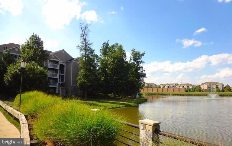 1701 Lake Shore Crest Drive, Unit 34 Reston, VA 20190 - Photo 19 of 28 a swimming pool view with a lake view