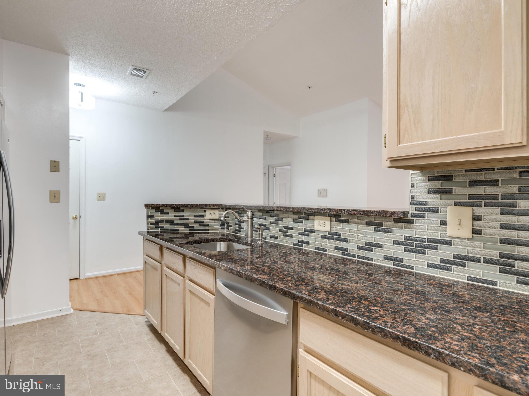 1701 Lake Shore Crest Drive, Unit 34 Reston, VA 20190 - Photo 3 of 28 a kitchen with granite countertop a sink and a stove