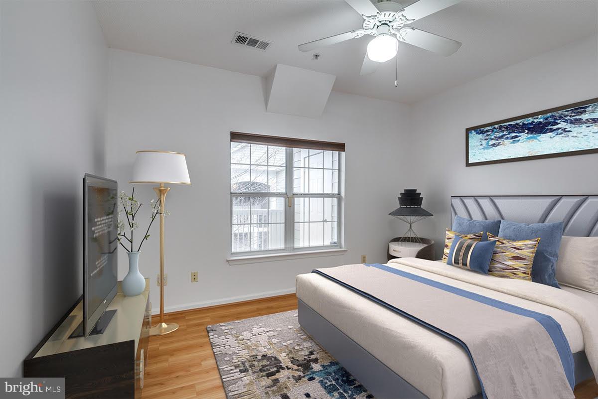1701 Lake Shore Crest Drive, Unit 34 Reston, VA 20190 - Photo 9 of 28 a bedroom with a bed and a chandelier