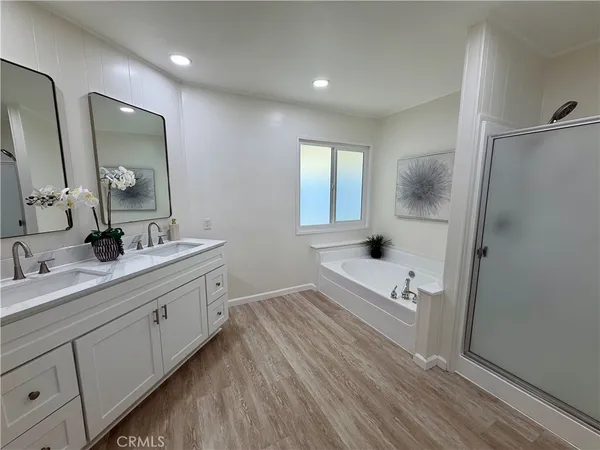 a bathroom with a double vanity sink toilet and a mirror