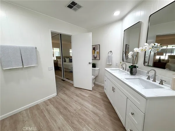 a bathroom with a sink and a glass door shower