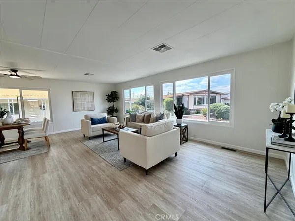 a large white room with a sink and mirror