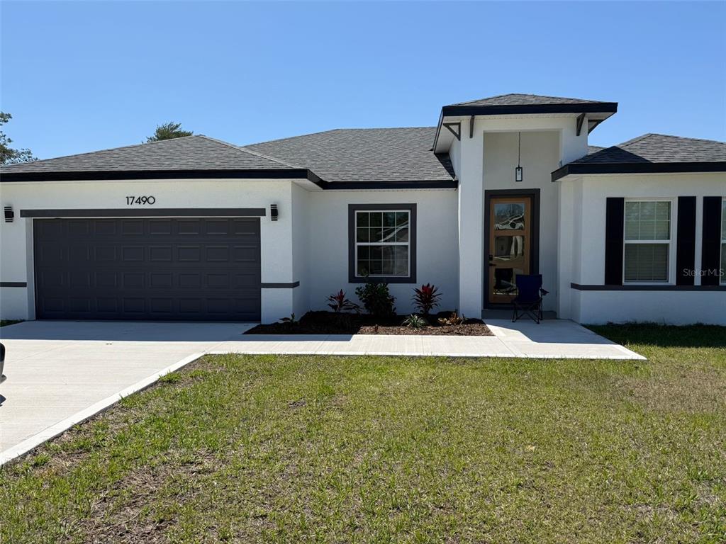 17490 Southwest 27th Circle Ocala, FL 34473 - Photo 1 of 12 a front view of a house with a yard