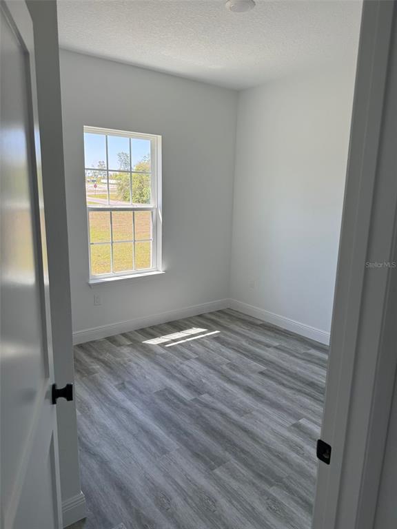17490 Southwest 27th Circle Ocala, FL 34473 - Photo 9 of 12 an empty room with wooden floor and windows