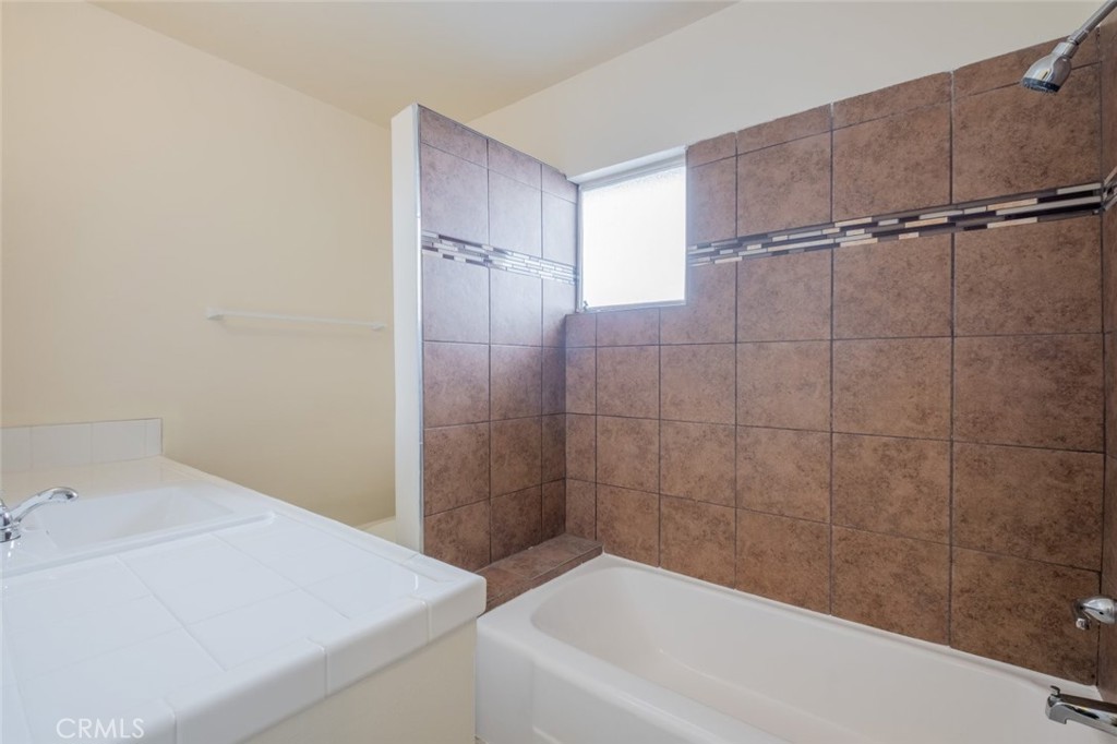 342 East Lancaster Boulevard Lancaster, CA 93535 - Photo 14 of 15 a bathroom with a bathtub and shower