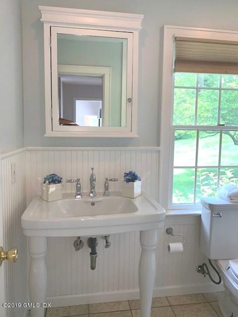 244 Stanwich Road Greenwich, CT 06830 - Photo 13 of 22 a bathroom with a sink and a mirror