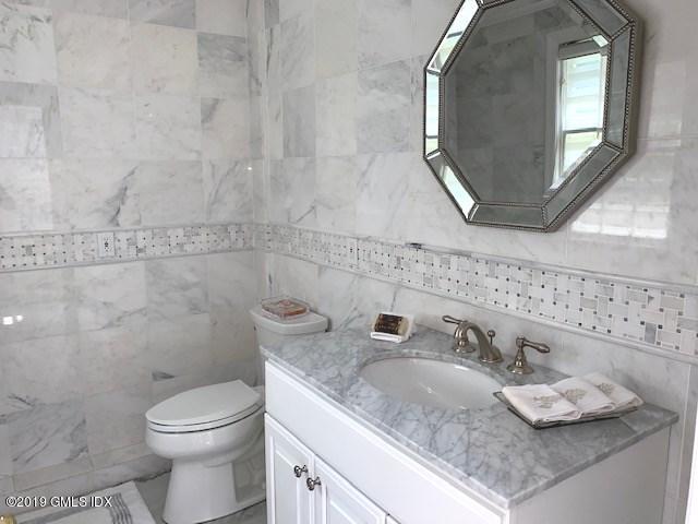 244 Stanwich Road Greenwich, CT 06830 - Photo 15 of 22 a bathroom with a granite countertop sink a toilet and a mirror
